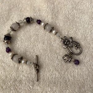 Beaded bracelet featuring white pearls, amethyst, clear crystal beads. Elephant